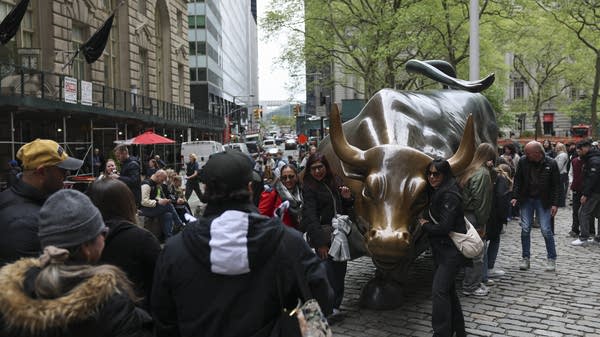 Tourists line up to take pictures with the Charging Bull, a symbol for American dynamism. 