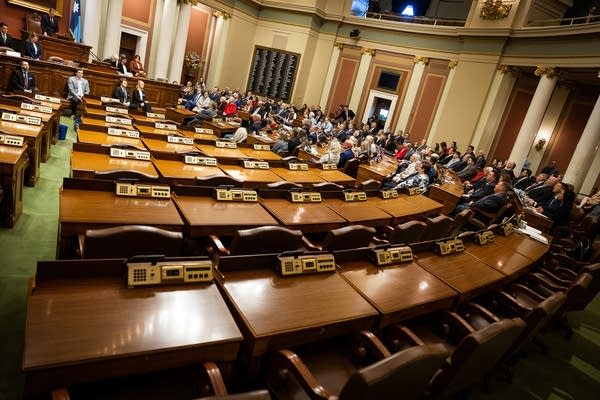 Empty desks fill half of a State House chamber