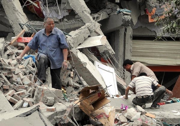 Rescuers search the rubble