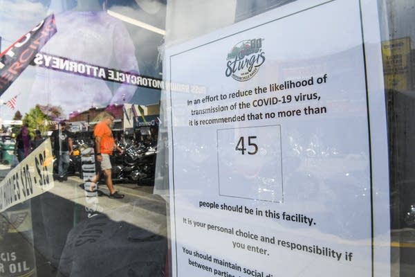 A sign on a storefront limiting occupants in Sturgis, South Dakota, on Aug. 6.
