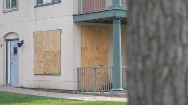 boarded up window on a townhome
