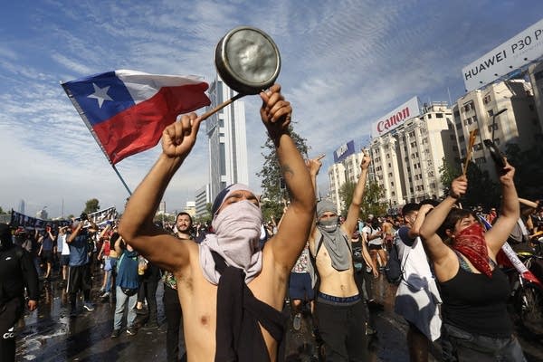 Demonstrators display flags and banners during a protest against President Sebastian Piñera in Santiago, Chile. (Photo by Marcelo Hernandez/Getty Images)