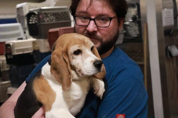 man holds dog