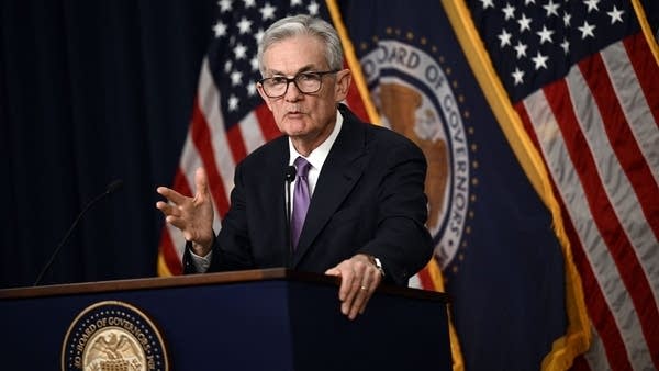 Jerome Powell stands at a podium during a press conference