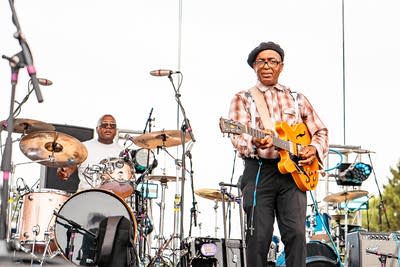 Nathan and the Zydeco Cha Chas performing on an outdoor stage.