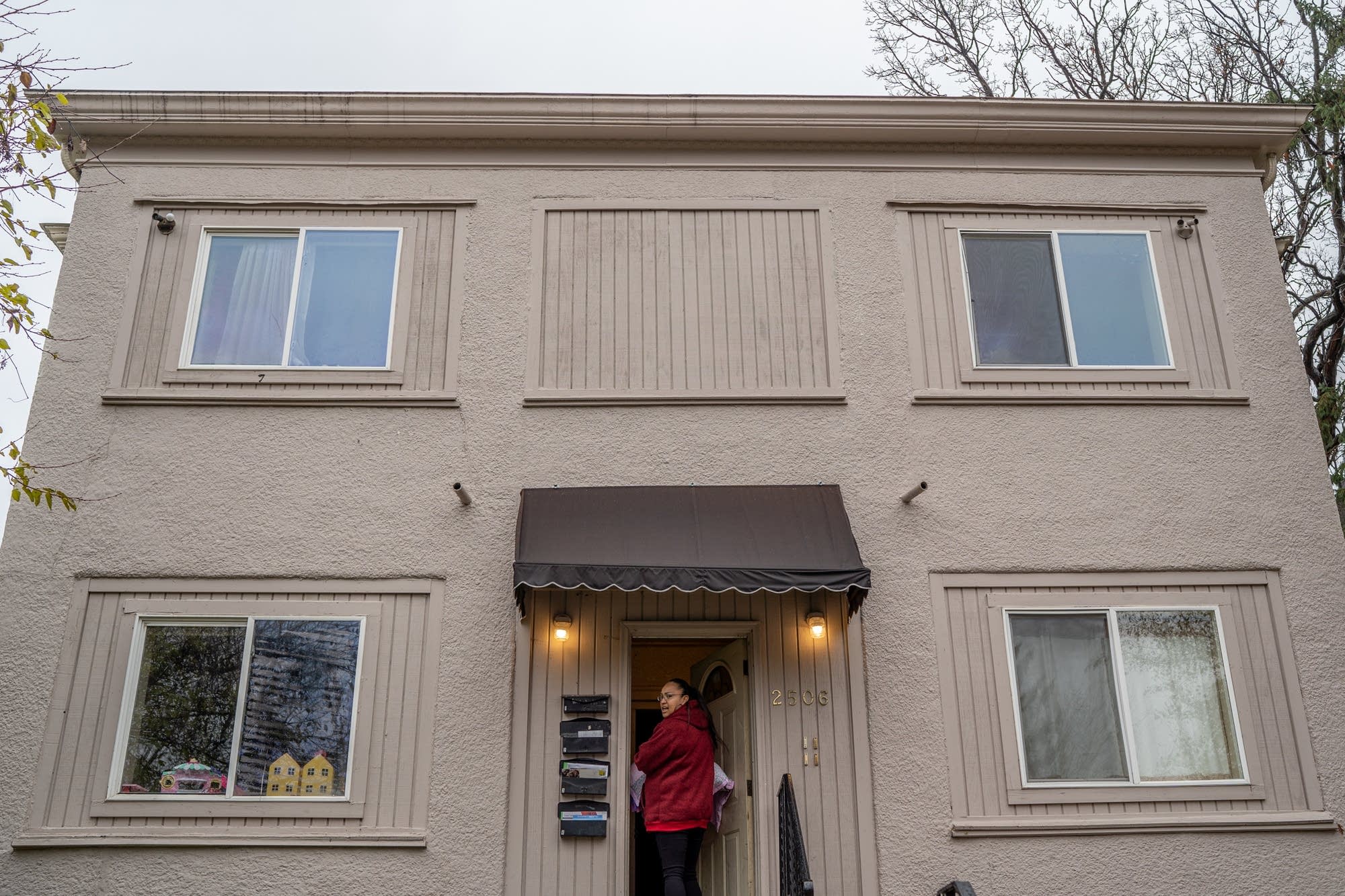 Melody Johnson enters a north Minneapolis building to look at an apartment.