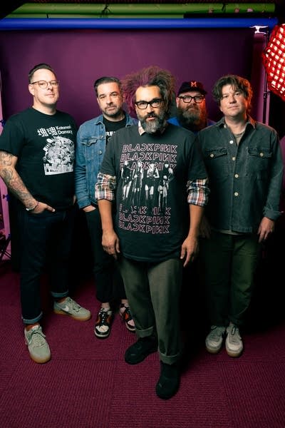 Five members of Motion City Soundtrack pose for a photo.