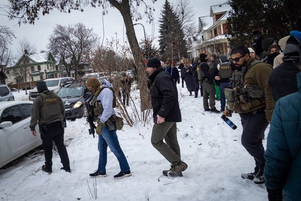 Federal agents walk toward their vehicles