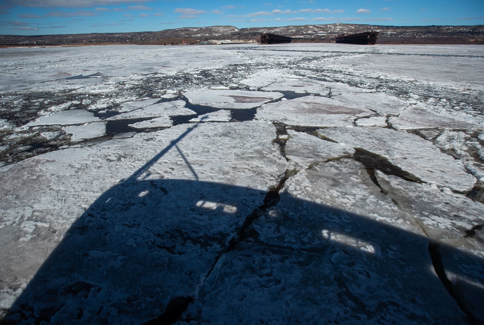 A shadow of the US Coast Guard Cutter Alder sits on the ice