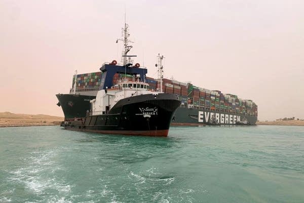 A handout picture released by the Suez Canal Authority on March 24, 2021 shows a part of the Taiwan-owned MV Ever Given, a 1,300-foot-long vessel, lodged sideways and impeding all traffic across the waterway of Egypt's Suez Canal. 