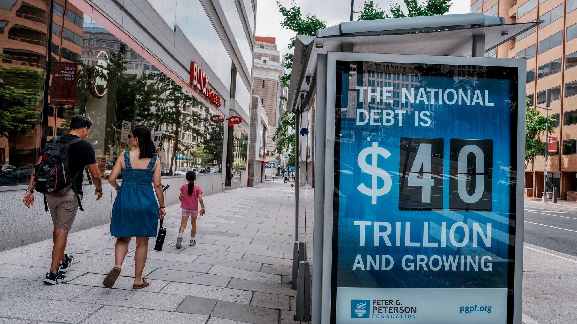 What happens to the deficit and national debt if interest rates stay high?