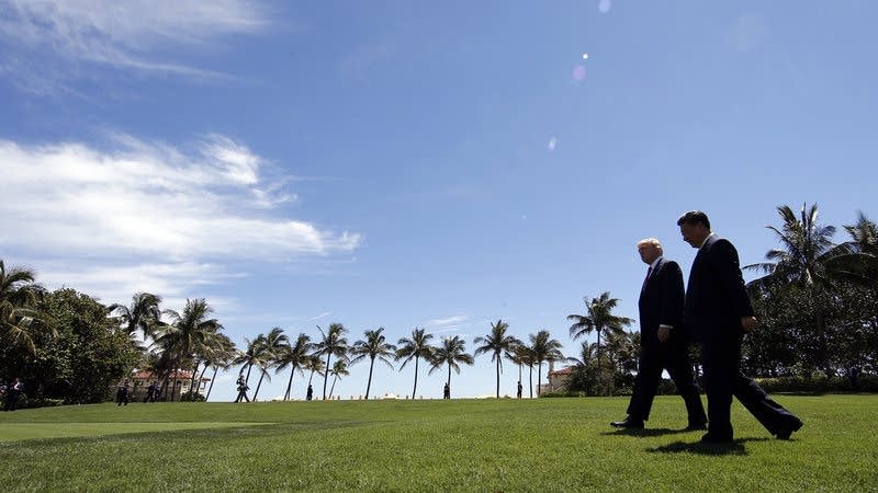 Trump and Chinese President Xi Jinping walk together after meetings.