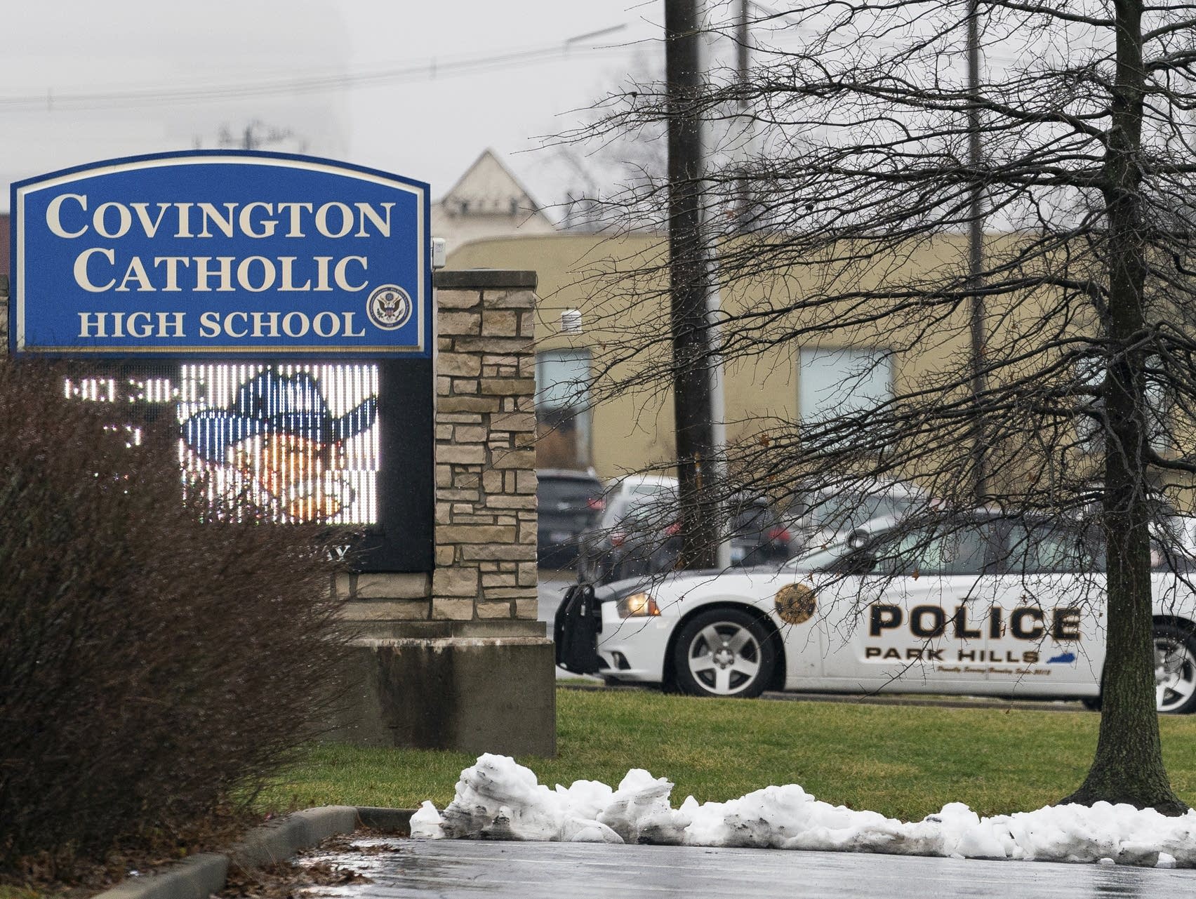 A police car sits at the entrance to Covington Catholic High School.
