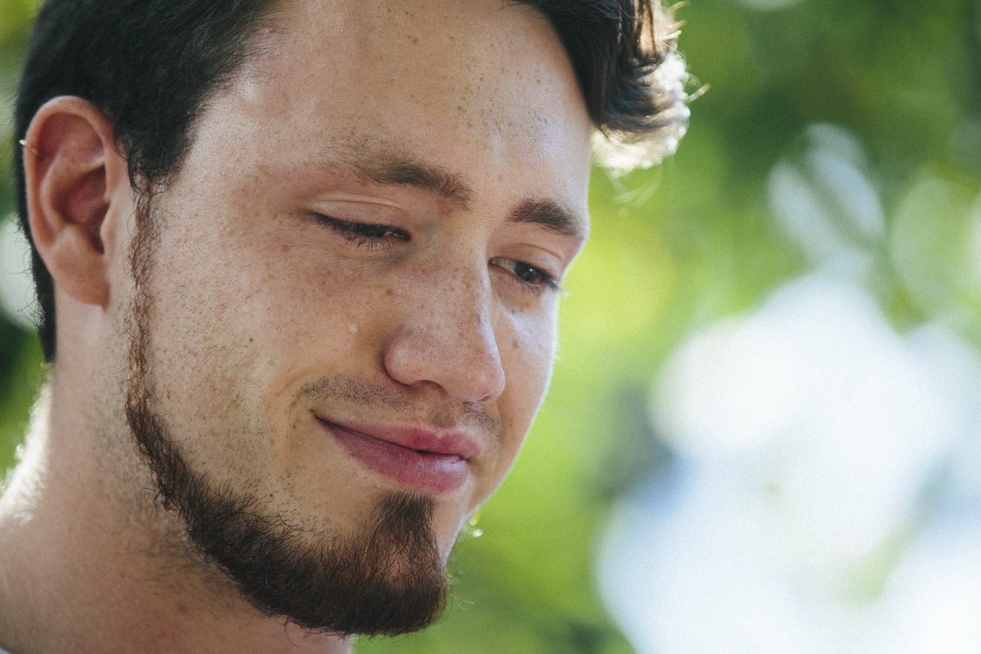 Tears run down Zach Damond's face as his father Don speaks.