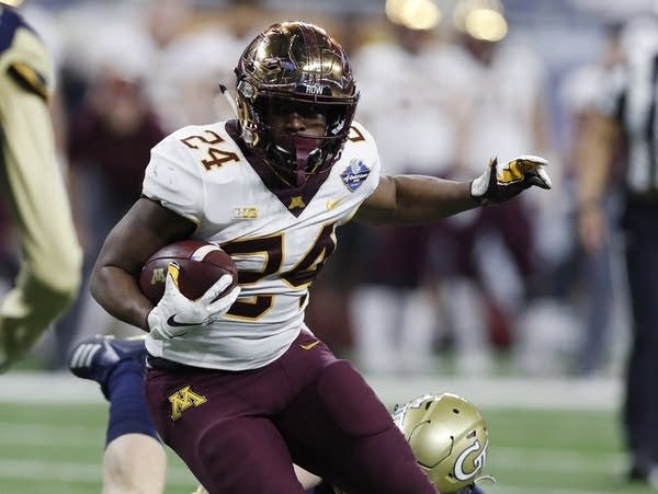 Mohamed Ibrahim runs in the Quick Lane Bowl game.