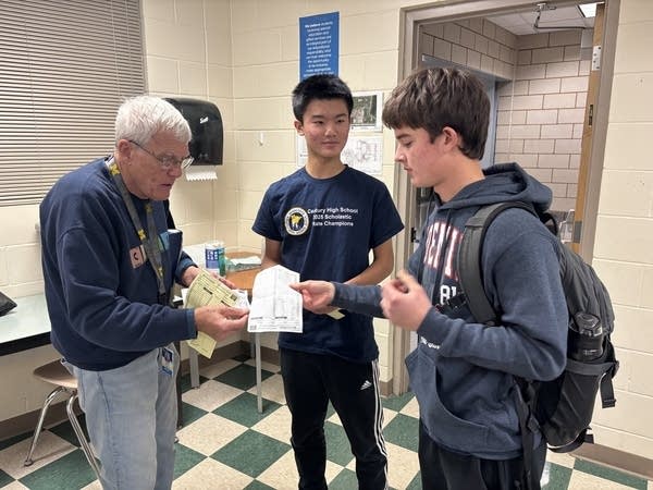 Teacher talking to two students