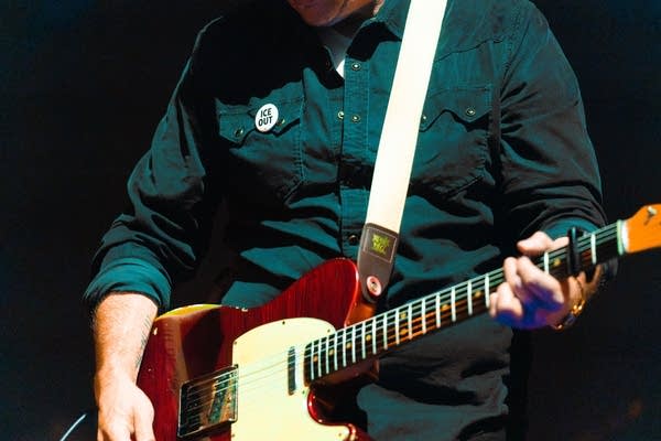 Close up of guitarist wearing ICE OUT pin