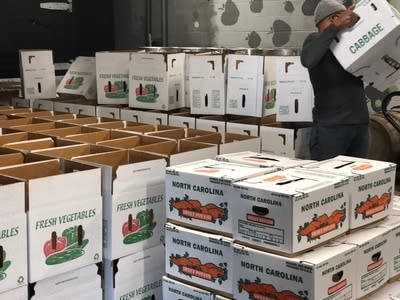 Boxes lined and stacked, waiting to be filled with food from Tall Grass Food Box.