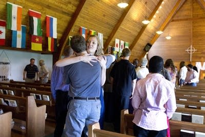 Laura Newby greets a fellow congregant