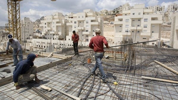 Construction workers at an East Jerusalem housing projects.