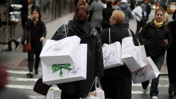 Shoppers carry bags on Fifth Avenue in New York City. 