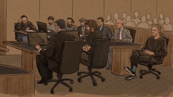 A court sketch of people in formal wear sitting in wheeled office chairs in a courtroom.