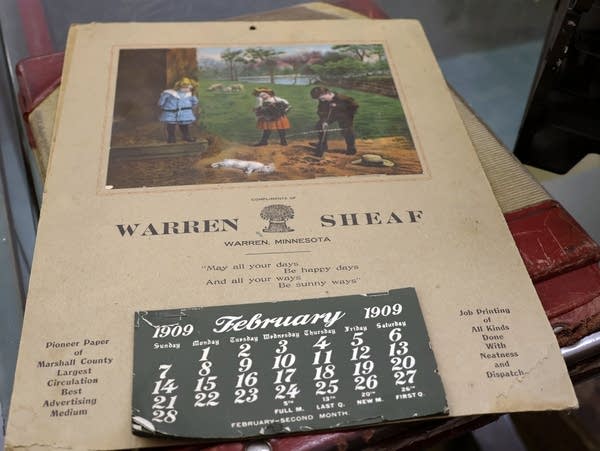 a faded calendar from 1909 lies on a counter 