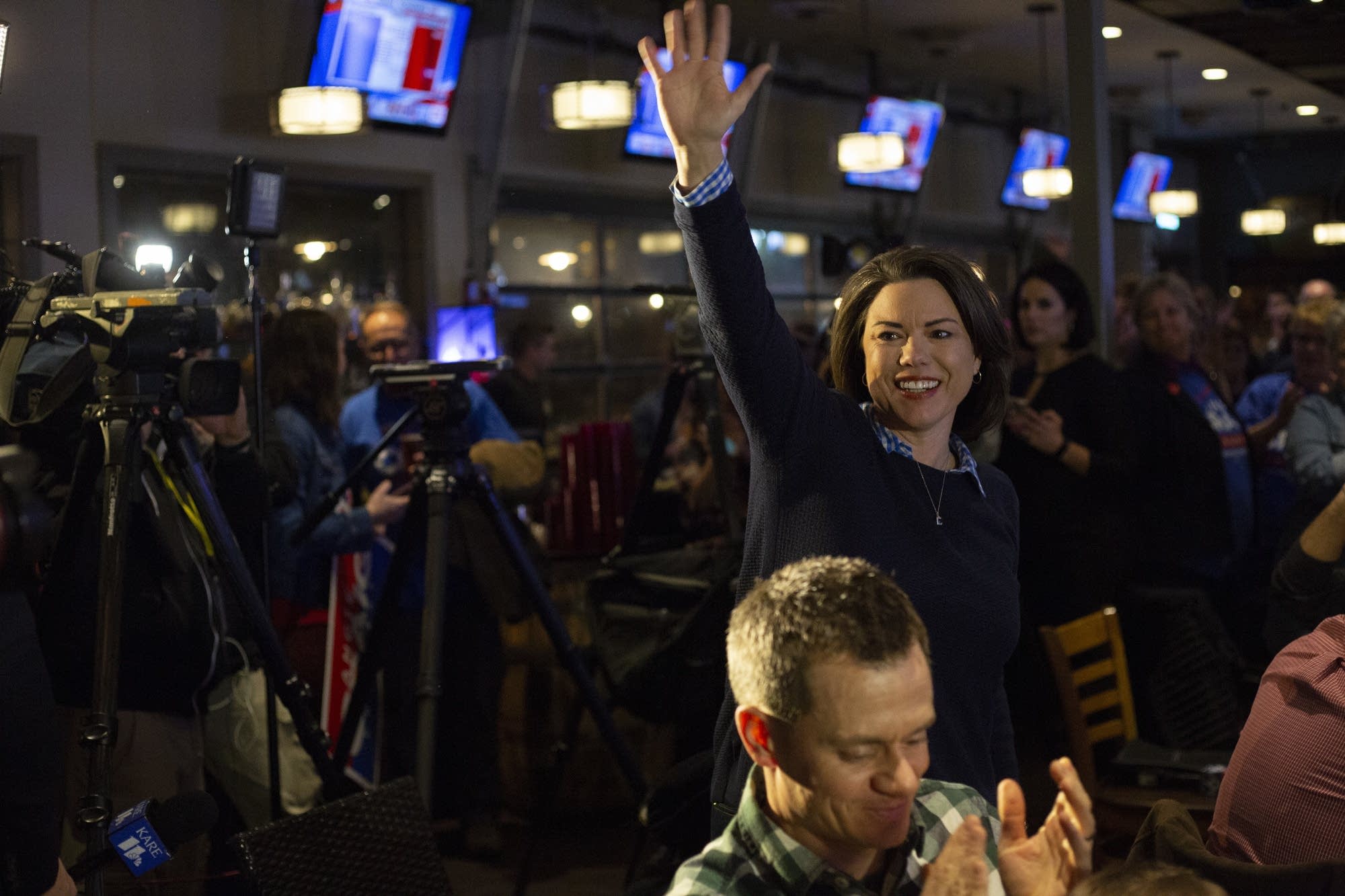 DFL Candidate Angie Craig waves as she enters her election party.