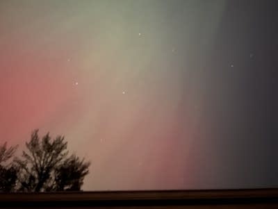 Green and red lights in the night sky.