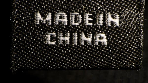 A photo illustration shows a label inside an item of clothing reading "Made in China" in New York on May 09, 2019. - US and Chinese officials resumed crucial trade talks on thursday, trying to resolve a year-long dispute that was on the verge of escalating with new US tariffs. 
With US punitive tariffs on $200 billion in Chinese goods set to jump to 25 percent just after midnight, President Donald Trump said earlier on May 9, 2019 that an agreement remains "possible."
