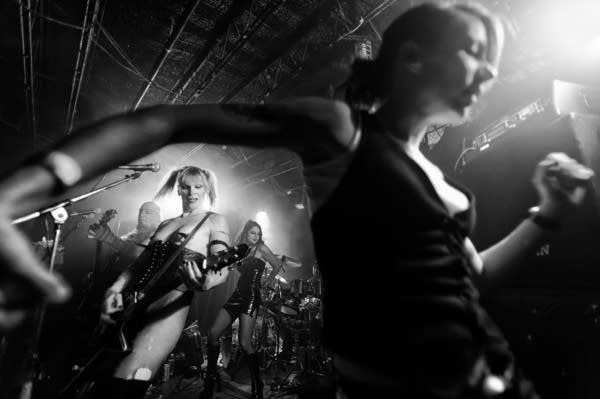 Venus DeMars performs in her old basement studio in the Colonial Warehouse building in the North Loop neighborhood of Minneapolis in 2009. Bassist Le Freak plays behind her, dancing behind her on the other side is Stacy Niven.The dancer in the foreground is Dawn McCool.