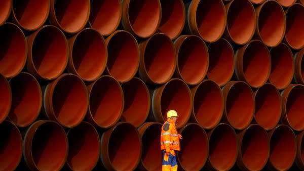 A worker walks in front of pipes which lie stacked at the Nord Stream 2 facility at Mukran on Ruegen Islandon October 19, 2017 in Sassnitz, Germany.