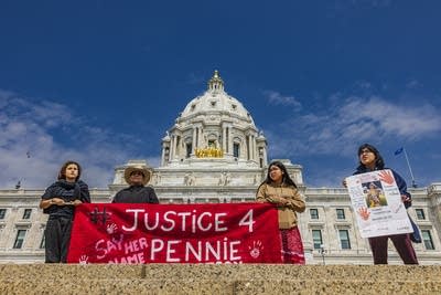 People hold a red banner