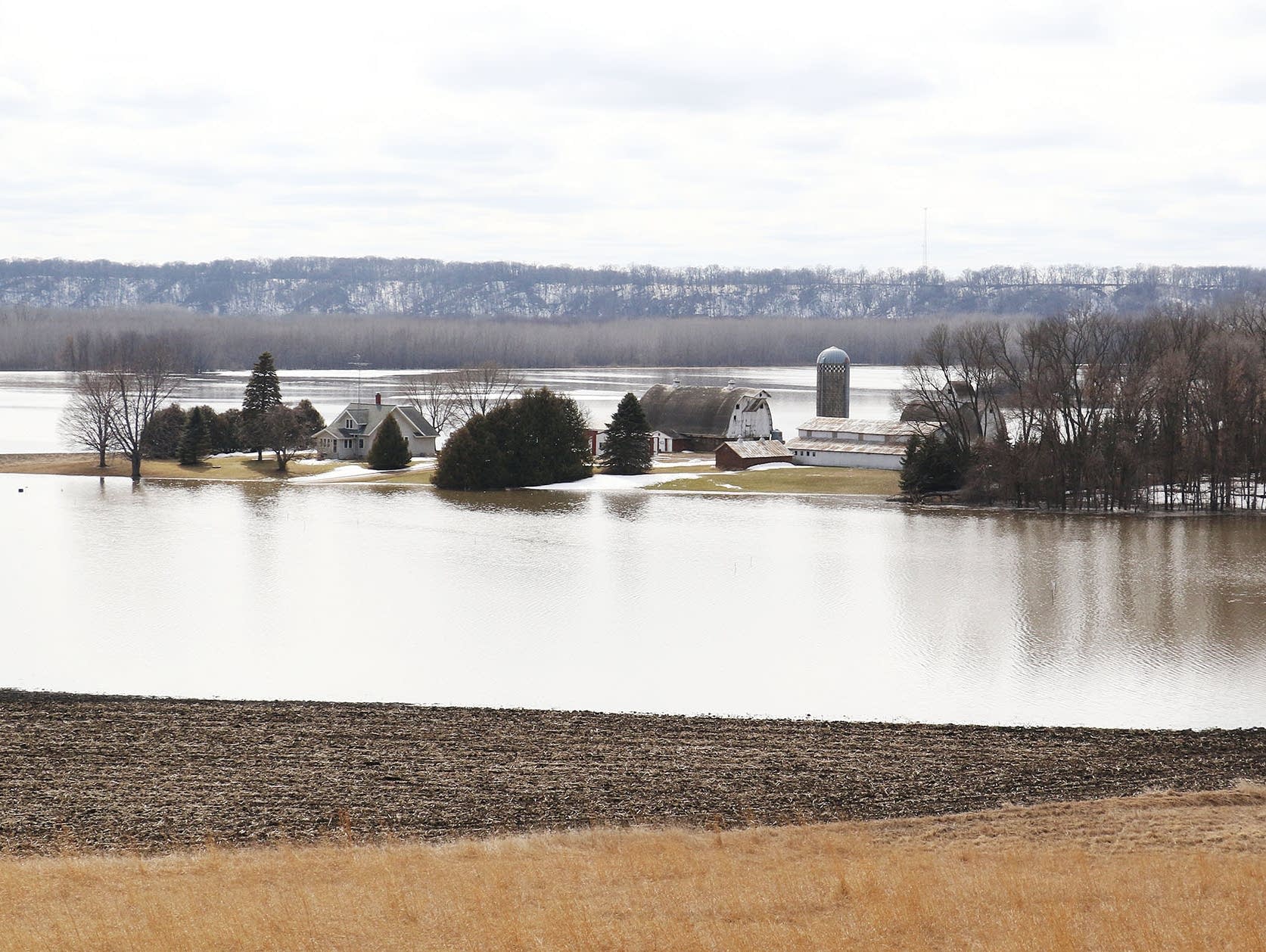 A farm is surrounded by the floodwaters of the Minnesota River