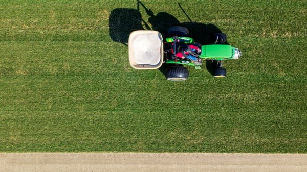 Above, a farmer spreads fertilizer in Connecticut. Farmers have been grappling with rising fertilizer costs, which could continue to climb as an Iran peace deal seems further away. 