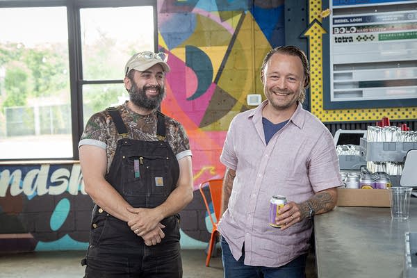 Two people stand and smile
