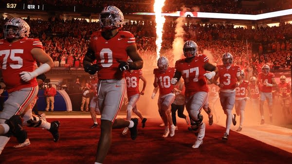 Above, Ohio State Buckeyes run onto the field before the 2025 Big Ten Football Championship in December 2025. According to The Athletic, Ohio State is estimated to have the most expensive roster in college football.