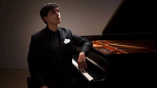 Poster Pianist Evren Ozel sits at a grand piano