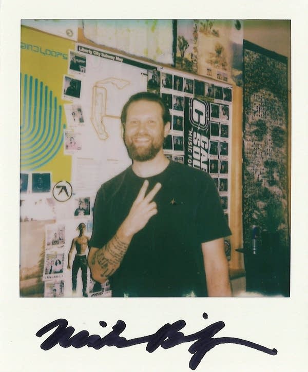 mike bishop posing for a polaroid photo