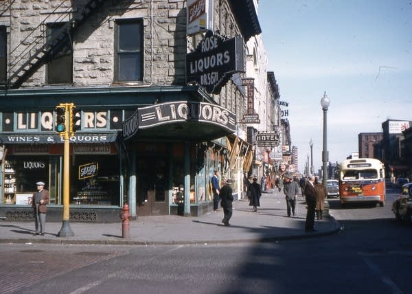 The corner of Nicollet and Washington was the heart of Minneapolis's Skid Row, now known as the Gateway District. This view shows Nicollet Avenue in the foreground and looks east on Washington Avenue.