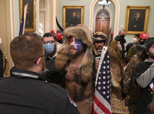 Pro-Trump extremists, including members of the QAnon conspiracy group, enter the U.S. Capitol on Jan. 6.
