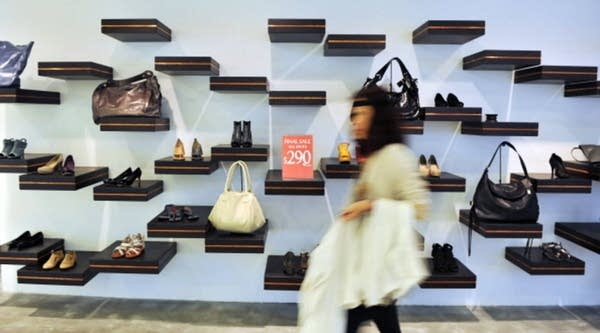 A shopper passes by a shop display in Hong Kong on Aug. 29, 2011.
