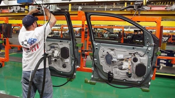 "You have to deal with what you're given. And right now, we've accepted the fact that the tariffs aren't going away," says Kevin Feig, president of Foreign Parts Distributors in Miami. Above, a worker assembles car door unit in Chicago.