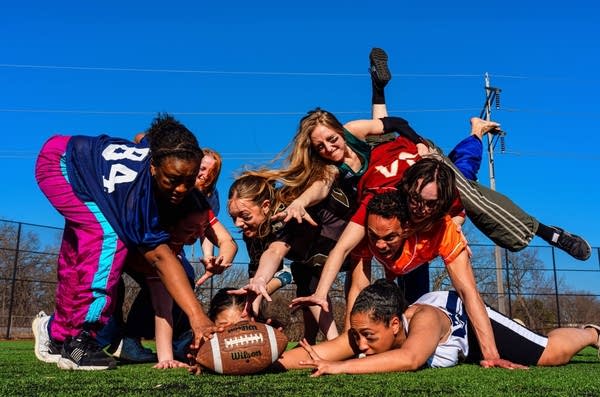 People fight over a football