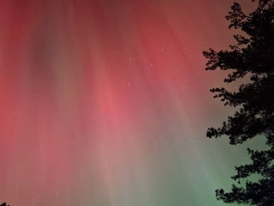 Red and green lights reach across the night sky.