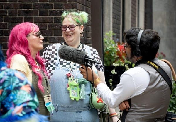 a radio reporter interviews two people