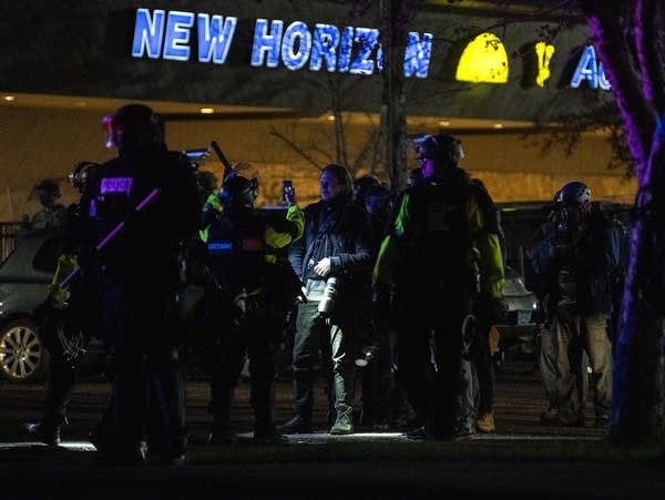 Law enforcement officers photograph journalists