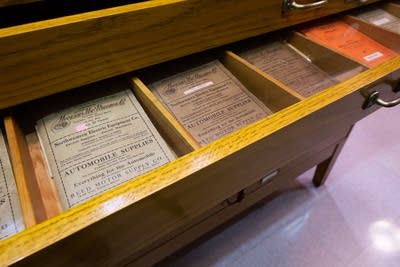 A drawer filled with historic road maps sits on display.