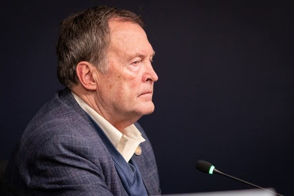A man listens during a meeting