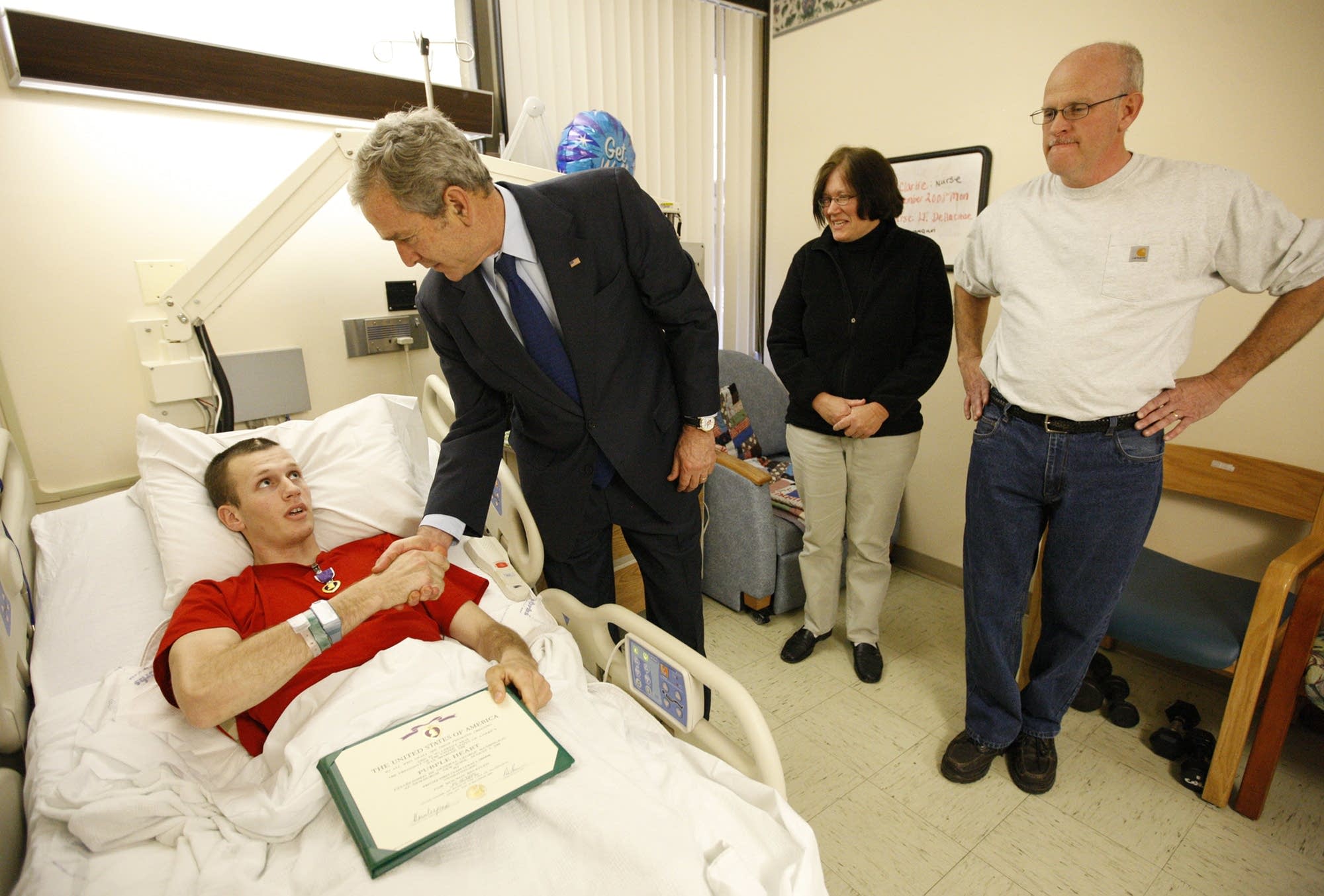 President Bush presents a Purple Heart to Army PFC Luka Shook.